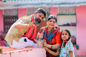 Happy indian farmer couple with daughter at home.