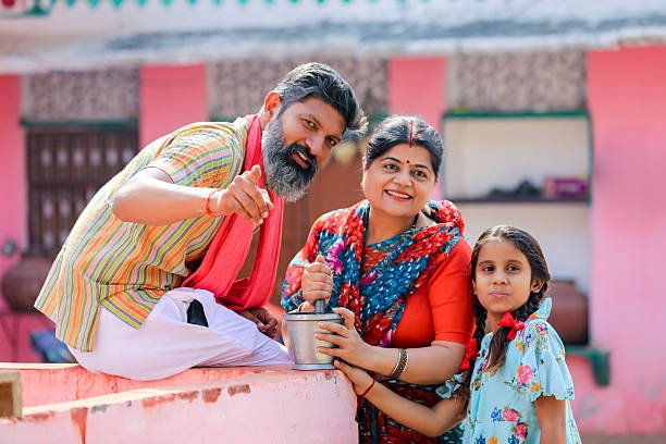 Happy indian farmer couple with daughter at home.